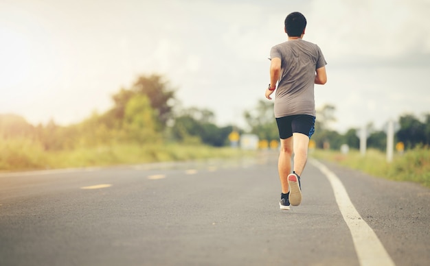 Young man running in the road for exercise.. Healthy lifestyle