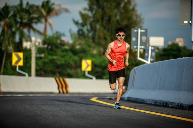 Young man running on the road in the morning