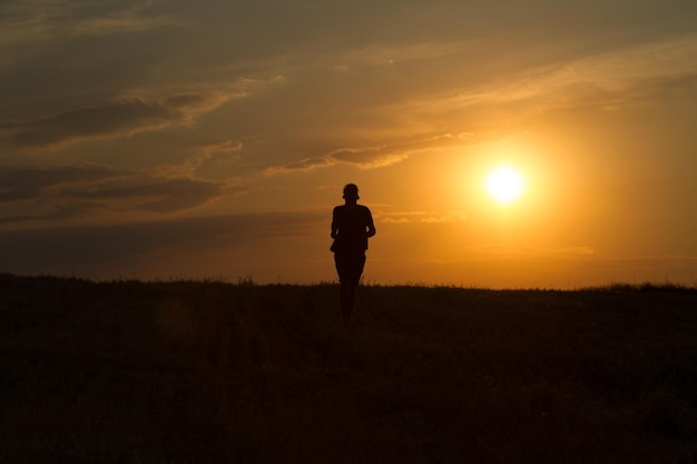 young man running and showing movement at sunset