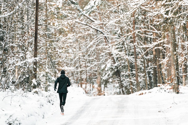 Young man running in winter in the park