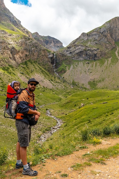 A young man next to the Salto de Tendenera Waterfall in the Ripera Valley Panticosa Pyrenees