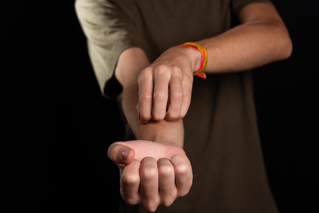 Young man scratching his arm with his hand Skin disease Irritation allergy