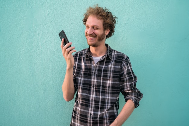 Young man sending voice message