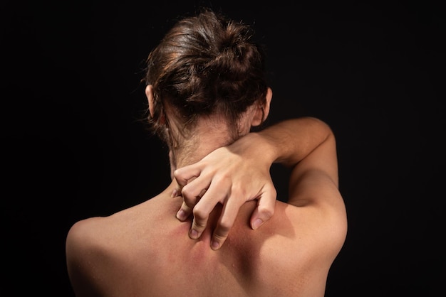 Young man shirtless scratching his back with his hands Skin disease Irritation allergy