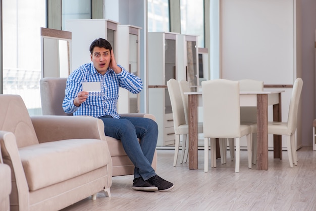 Young man shopping in furniture store