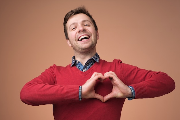 Young man show heart gesture with hands