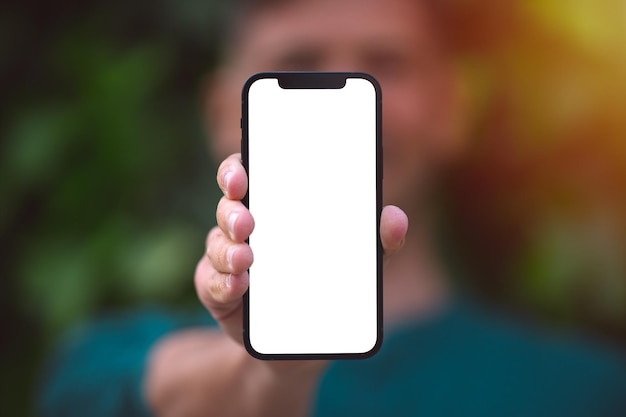 Young man showing his phone with white mockup screen