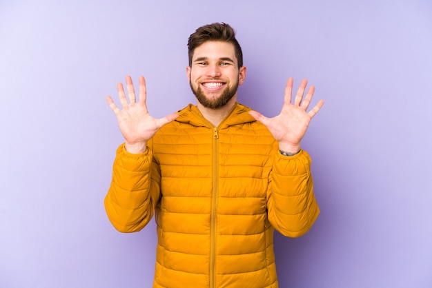 Young man showing number ten with hands.