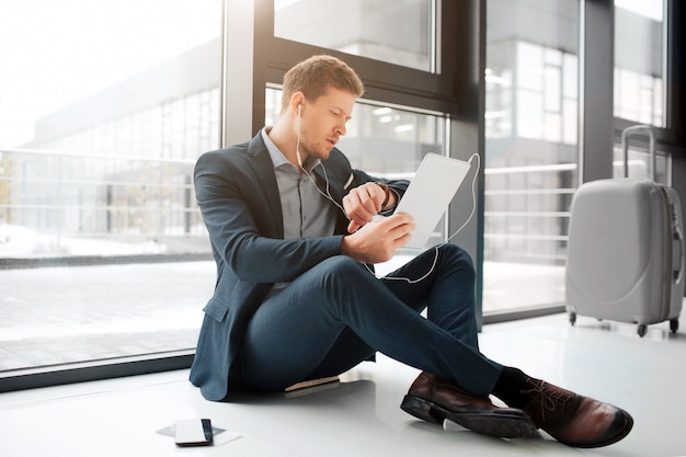 Young man sit on floor