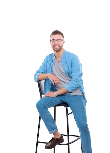 Young man sitting on the chair isolated over white background Startupper Young entrepreneur