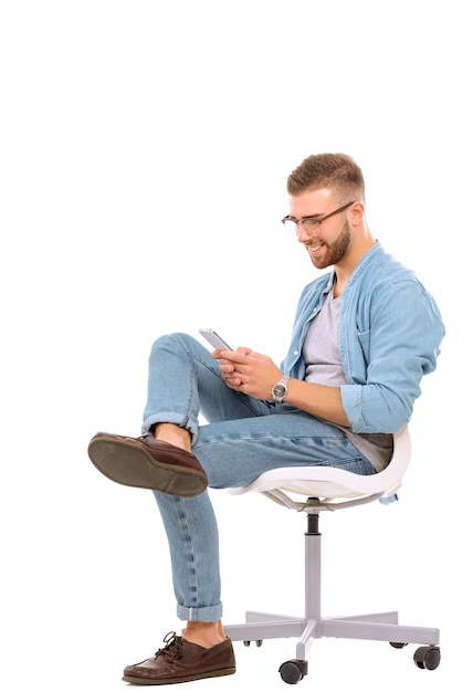 Young man sitting on chair and using mobile phone Startupper Young entrepreneur