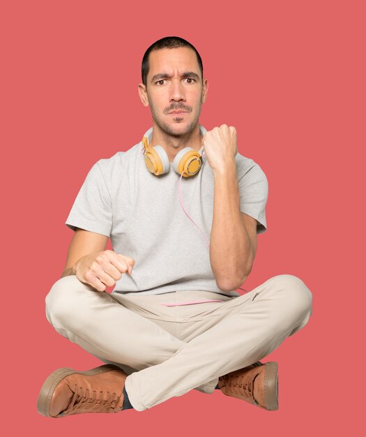 Young man in sitting position with a celebration gesture