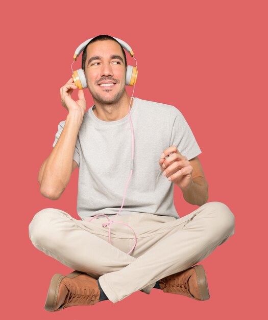 Young man in sitting position with a satisfaction gesture