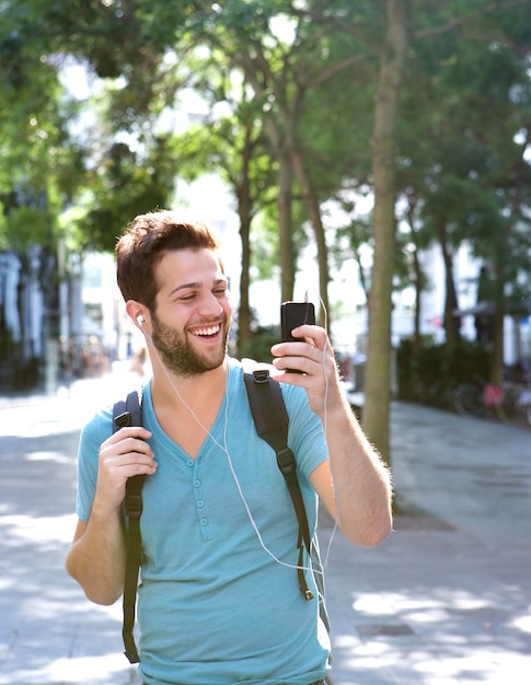 Young man smiling and holding mobile phone