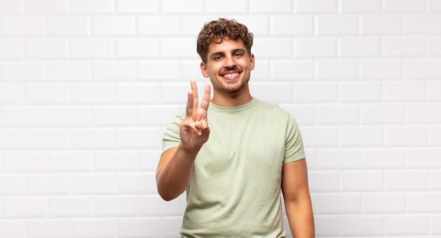 Young man smiling and looking friendly isolated