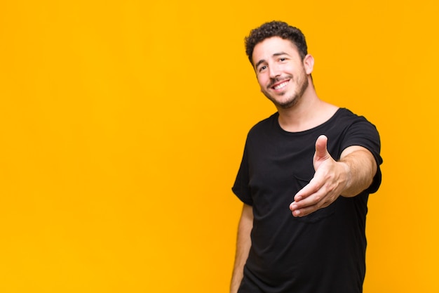 Young man smiling offering a handshake