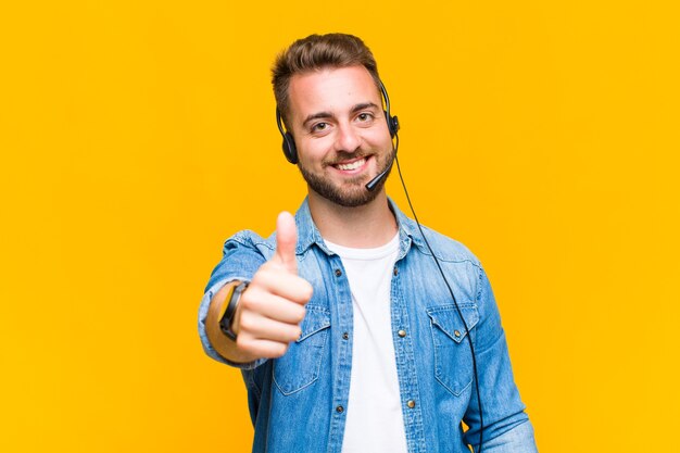 Young man smiling positively with thumbs up