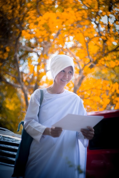 Young man standing by tree during autumn