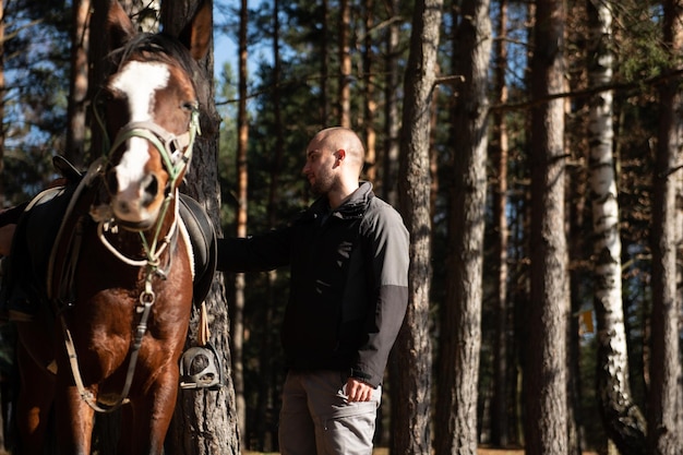 Young Man Standing Near Horse Preparing to Ride