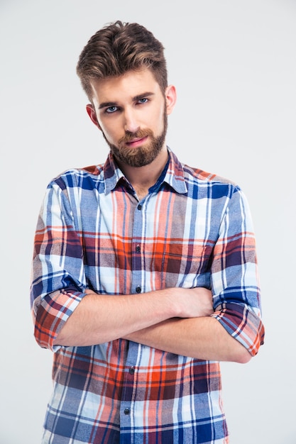 Young man standing with arms folded