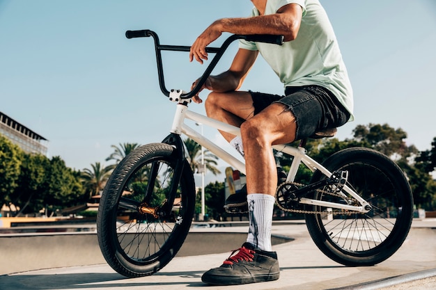 Young man stitting on his bmx low ange shot