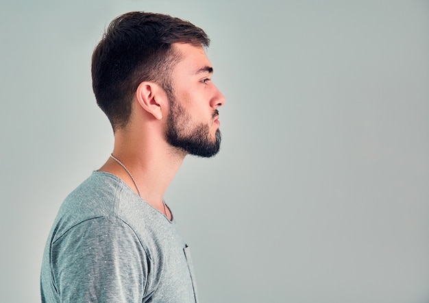 Young man in the studio on a gray background