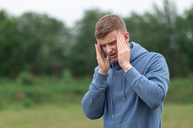 Young man suffering from severe headache