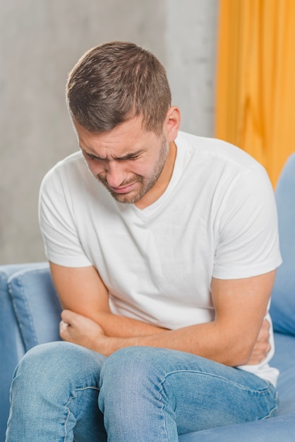 Young man suffering from stomach ache