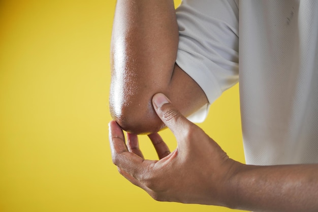 Young man suffering pain on elbow