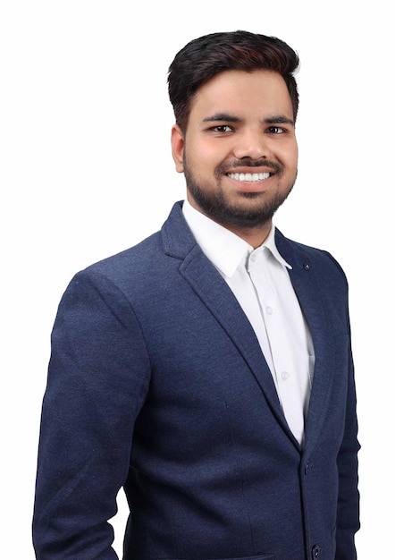 A young man in a suit and a white shirt is smiling.