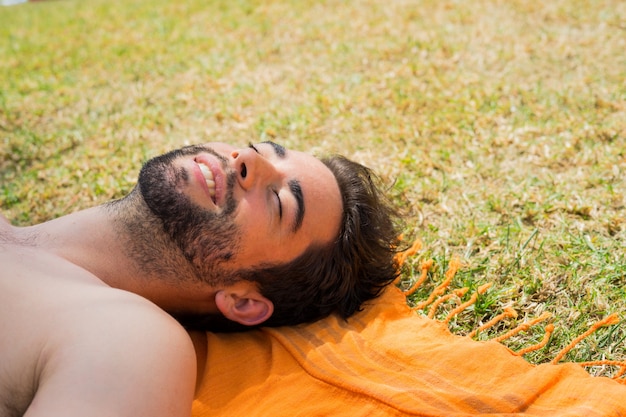 Young man sunbathing in the pool