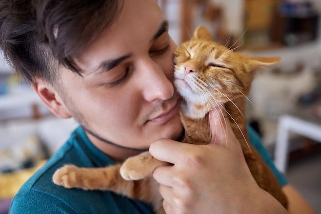 Young man in t shirt holding a cat