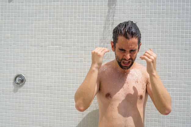 Young man taking a shower