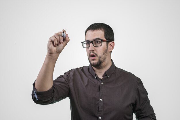 Young man thinking with marker in hand