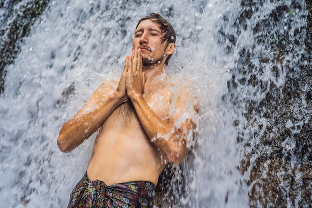 Young man tourist in Holy springs Sebatu in Bali