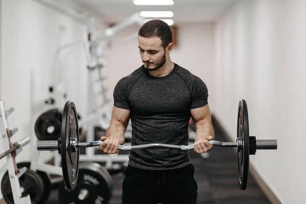 Young man trains his body to stay fit and have defined muscles