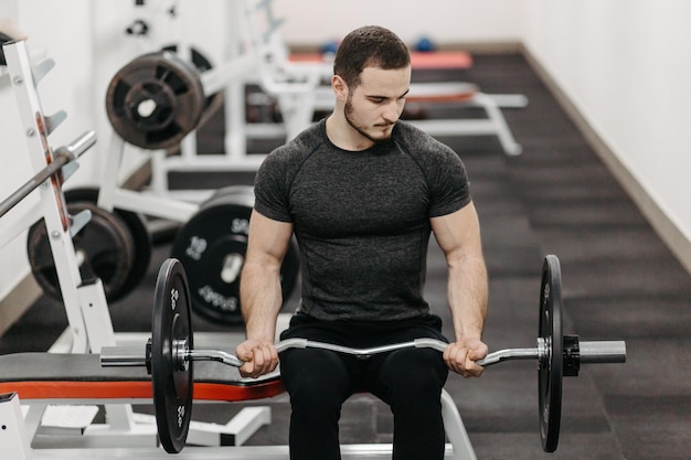 Young man trains his body to stay fit and have defined muscles