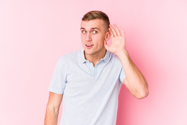 Young man trying to listening a gossip.