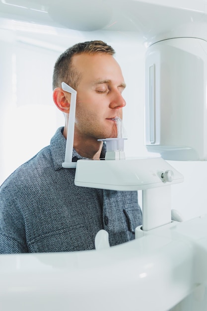 A young man underwent a CT scan of the jaw a circular image of the jaw in modern dentistry Radiology panoramic scanner