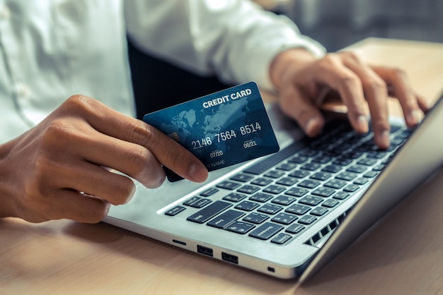 Young man uses credit card for online shopping