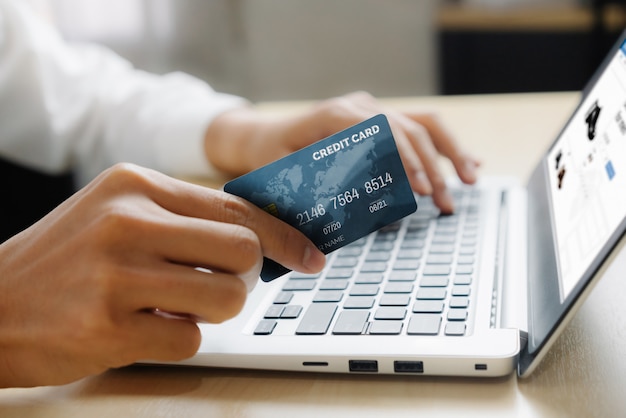 Young man using a credit card for online shopping