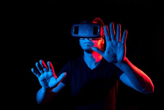 A young man using high-tech virtual reality glasses