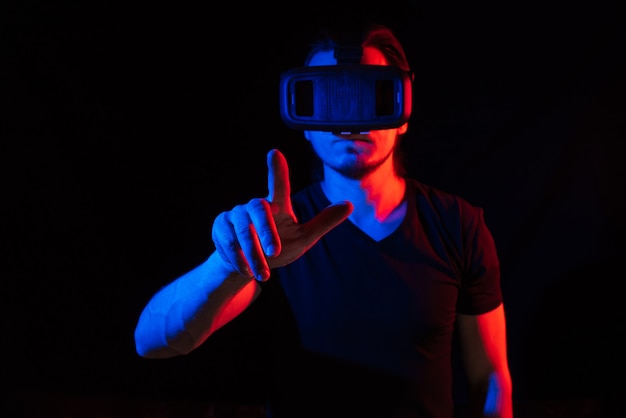 A young man using high-tech virtual reality glasses