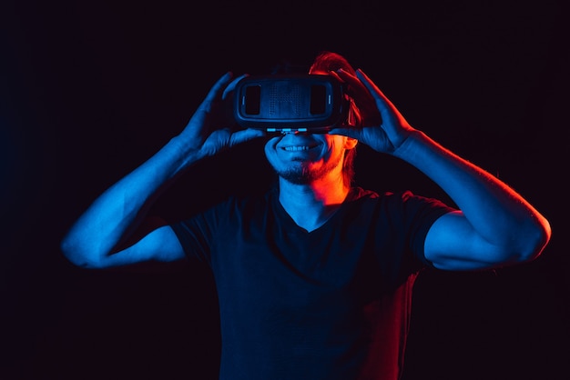 A young man using high-tech virtual reality glasses