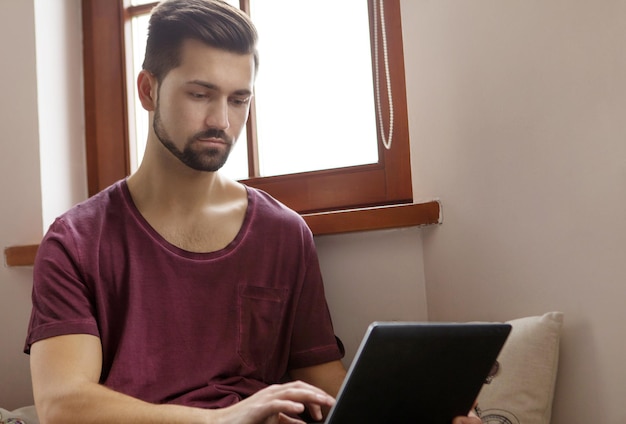 Young man using laptop at home