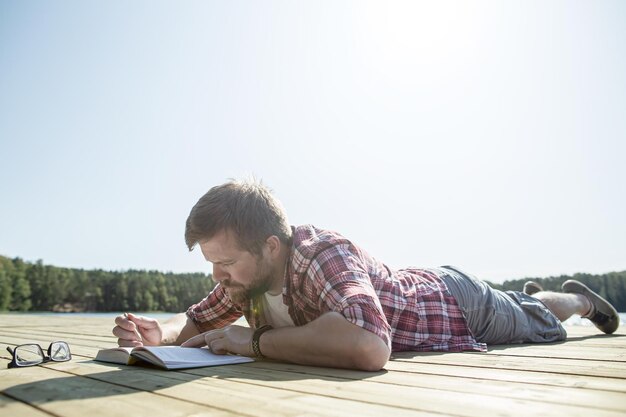 Young man using smart phone against sky