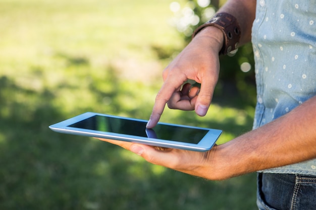 Young man using tablet in the park