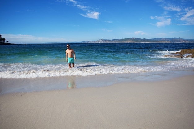 young man walking in the beach