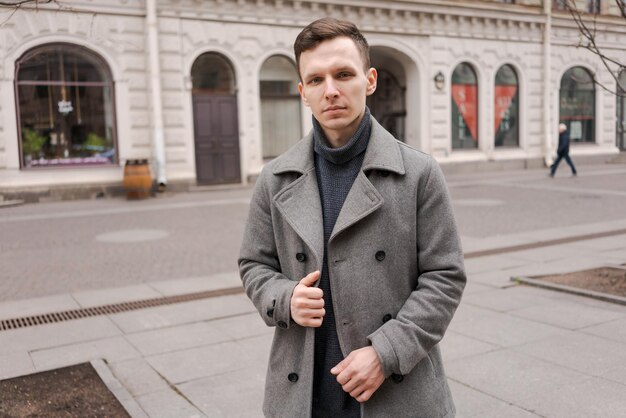 Young man walking down street autumn or winter cold day Outdoors outside