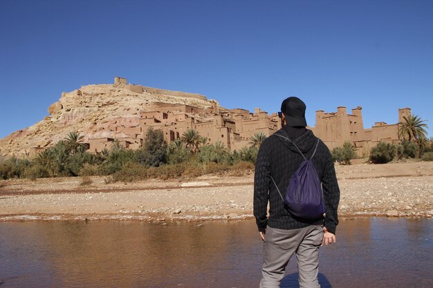 A young man watching Ksar Ait Ben Haddou Ksar Ait Ben Haddou Morocco